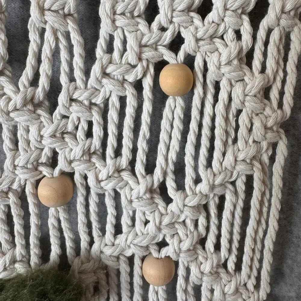 handmade boho-style macramé wall hanging crocheted flowers wooden beads fringe